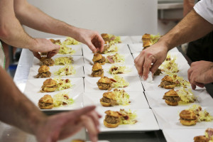 Plating duck confit sliders for the High Roller Tour at Isa's Bistro.