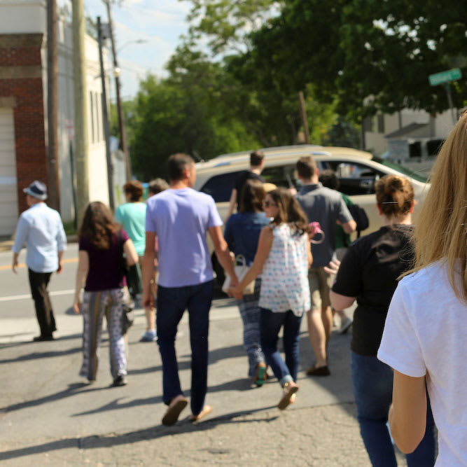 A tour group walks through downtown Asheville in the summertime